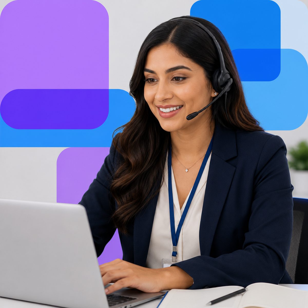 A contact center agent wearing a headset works at a laptop.
